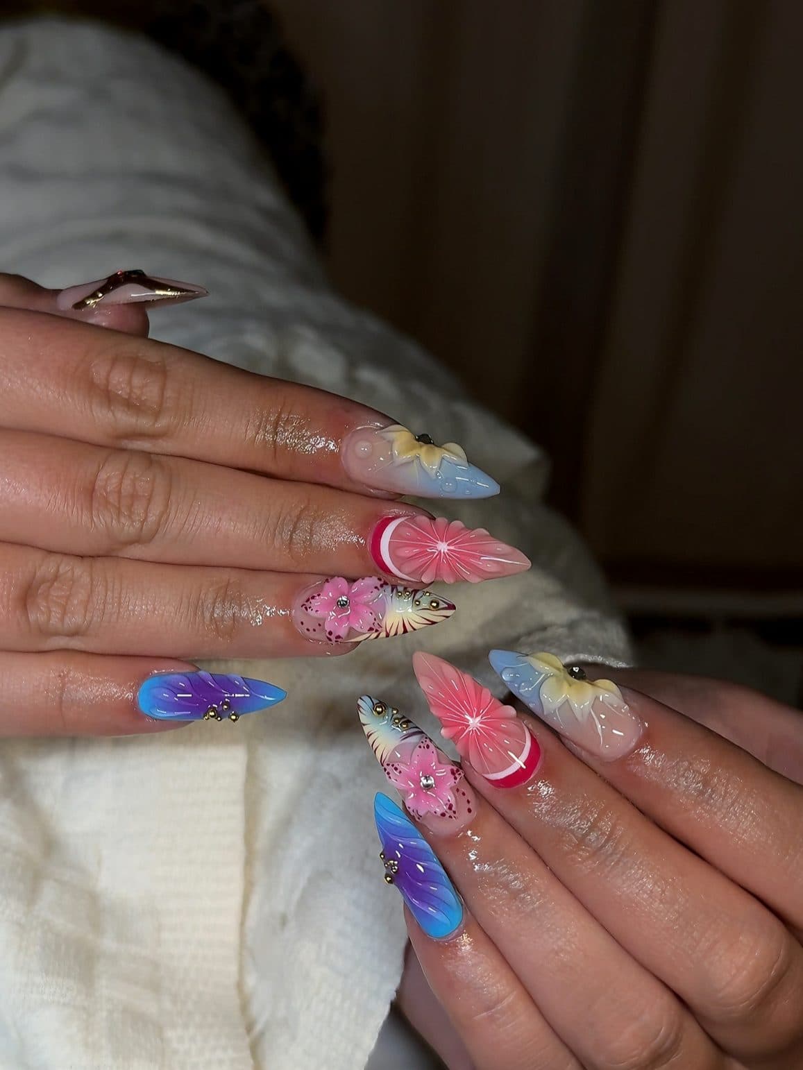 Stiletto Gel-X set with 3D pink and purple flowers, coral swirls and gem accents