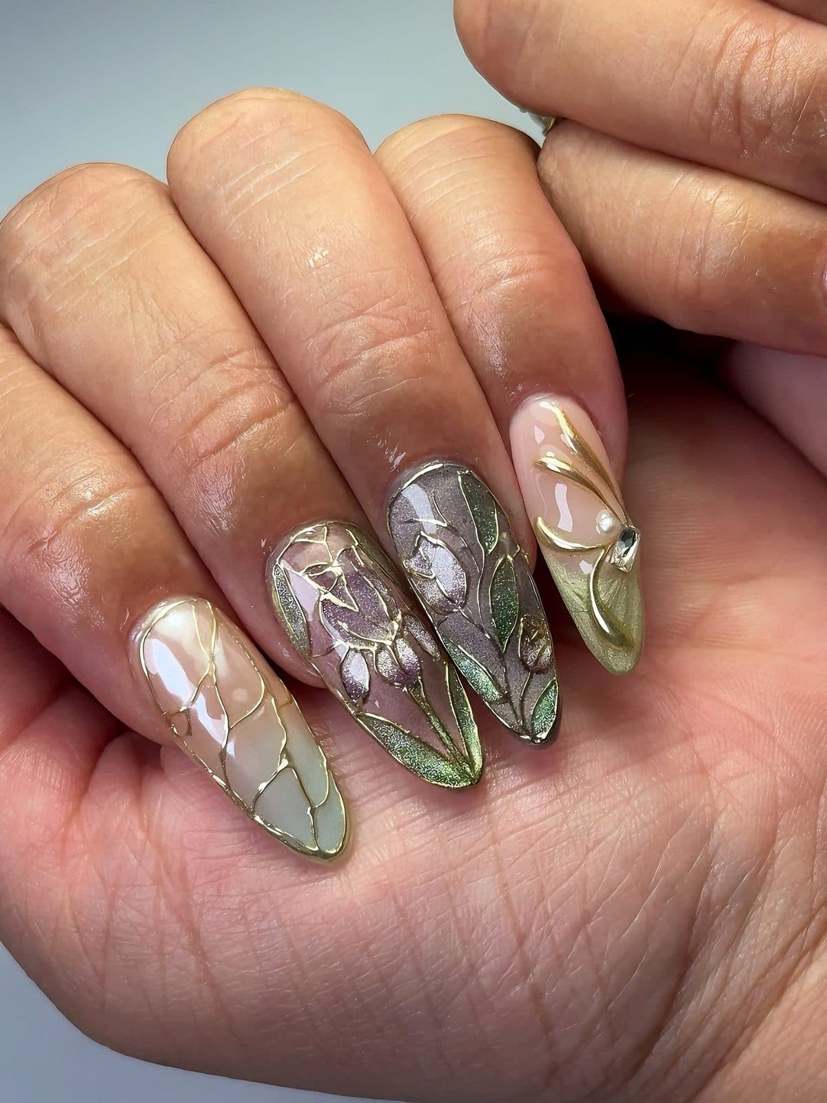 Almond Gel-X set with iridescent green-grey chrome, embossed florals and gold wire