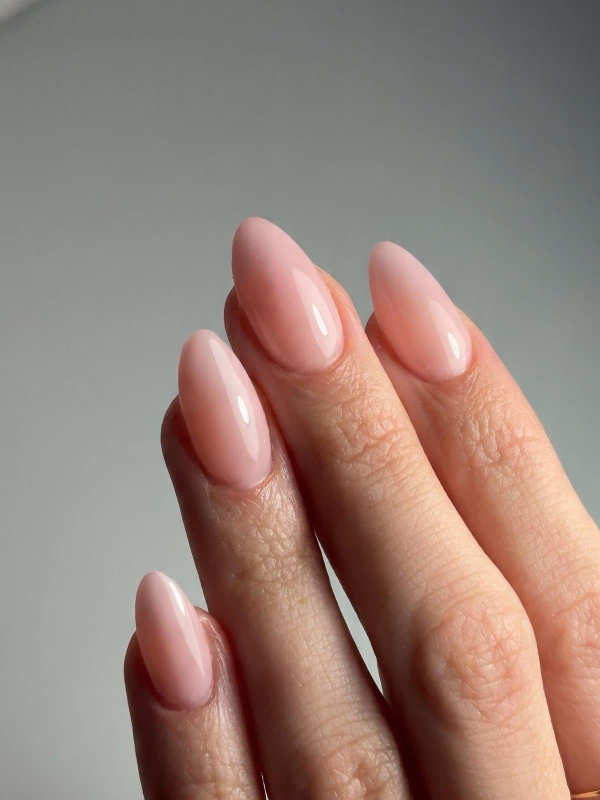 Natural sheer pink almond Gel-X extensions with a glossy finish